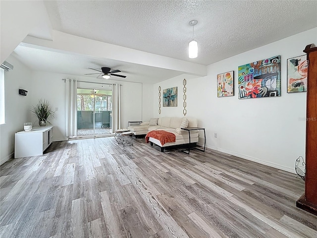 147 114th Ave NE Unit 147, Saint Petersburg, FL 33716 - living room featuring wood finished floors, a textured ceiling, ceiling fan, and baseboards