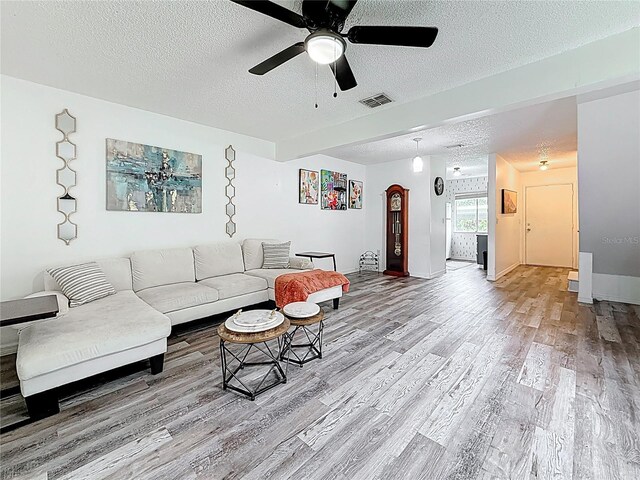 147 114th Ave NE Unit 147, Saint Petersburg, FL 33716 - living room featuring wood finished floors, a textured ceiling, a ceiling fan, and baseboards