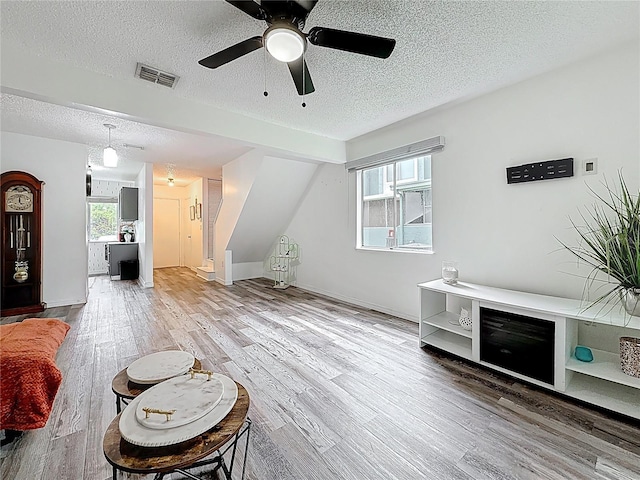 147 114th Ave NE Unit 147, Saint Petersburg, FL 33716 - living area with a textured ceiling, wood finished floors, a ceiling fan, and baseboards