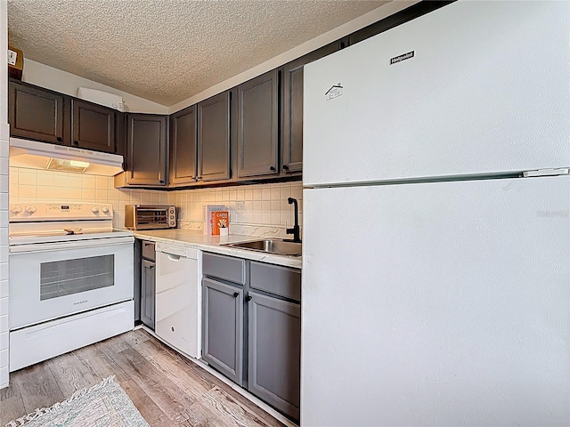 147 114th Ave NE Unit 147, Saint Petersburg, FL 33716 - kitchen with white appliances, under cabinet range hood, a textured ceiling, a sink, and decorative backsplash