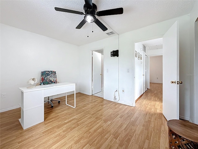 147 114th Ave NE Unit 147, Saint Petersburg, FL 33716 - home office with light wood-style flooring, ceiling fan, a textured ceiling, and baseboards