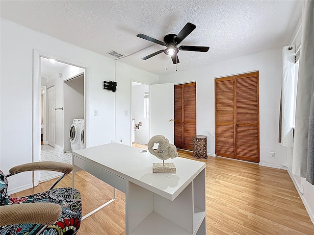 147 114th Ave NE Unit 147, Saint Petersburg, FL 33716 - home office with separate washer and dryer, ceiling fan, light wood-style floors, a textured ceiling, and baseboards