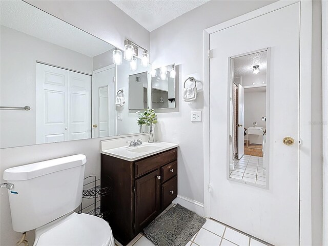 147 114th Ave NE Unit 147, Saint Petersburg, FL 33716 - full bath with a textured ceiling, toilet, vanity, and tile patterned flooring