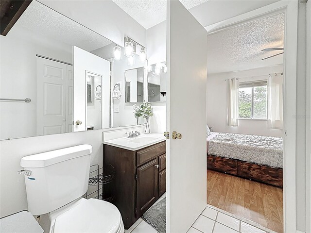 147 114th Ave NE Unit 147, Saint Petersburg, FL 33716 - bathroom featuring a textured ceiling, ensuite bathroom, toilet, vanity, and tile patterned flooring