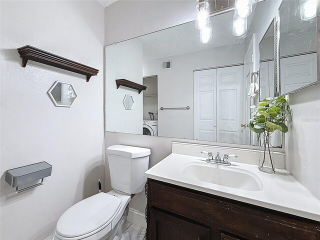 147 114th Ave NE Unit 147, Saint Petersburg, FL 33716 - half bathroom featuring washer / clothes dryer, toilet, vanity, and baseboards