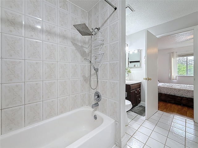 147 114th Ave NE Unit 147, Saint Petersburg, FL 33716 - full bath featuring a textured ceiling, vanity, tile patterned floors, washtub / shower combination, and connected bathroom