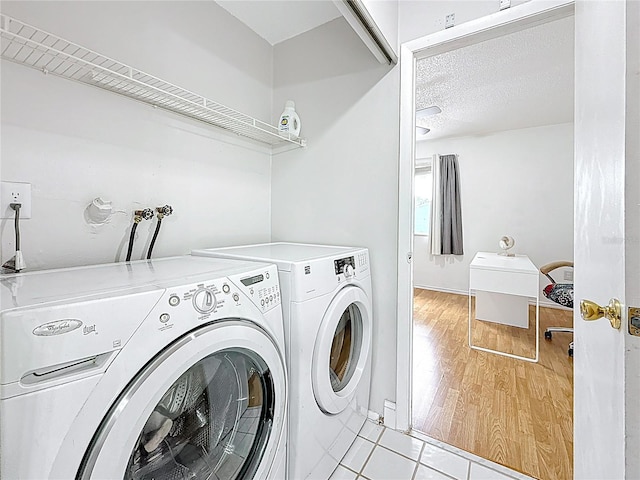 147 114th Ave NE Unit 147, Saint Petersburg, FL 33716 - laundry room with separate washer and dryer, light tile patterned floors, and baseboards
