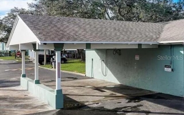 147 114th Ave NE Unit 147, Saint Petersburg, FL 33716 - garage featuring a carport