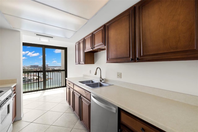 9425 Blind Pass Rd Unit 1008, St Pete Beach, FL 33706 - kitchen with a sink, stainless steel dishwasher, light countertops, light tile patterned flooring, and range