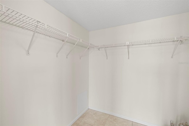 9425 Blind Pass Rd Unit 1008, St Pete Beach, FL 33706 - walk in closet with light tile patterned flooring
