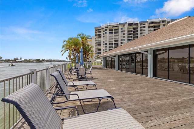 9425 Blind Pass Rd Unit 1008, St Pete Beach, FL 33706 - wooden terrace featuring outdoor dining area and a water view