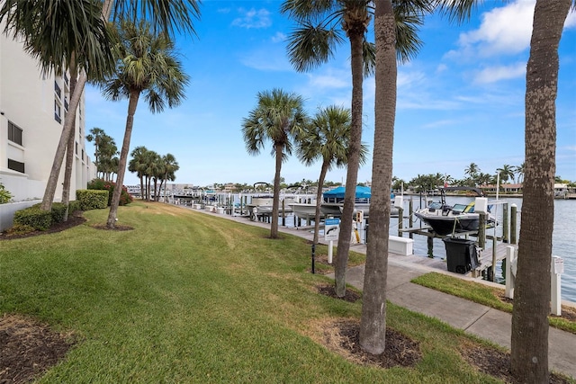 9425 Blind Pass Rd Unit 1008, St Pete Beach, FL 33706 - dock area featuring boat lift, a yard, and a water view