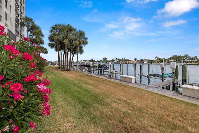 9425 Blind Pass Rd Unit 1008, St Pete Beach, FL 33706 - dock area with a lawn, a water view, and boat lift