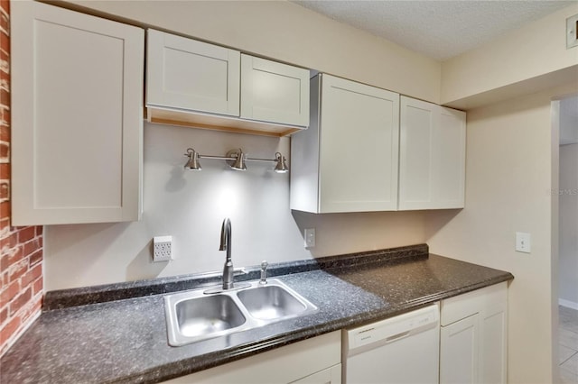 125 Picardy Villa Cir Unit 100, Brandon, FL 33510 - kitchen featuring white dishwasher, a sink, white cabinets, a textured ceiling, and tile patterned flooring