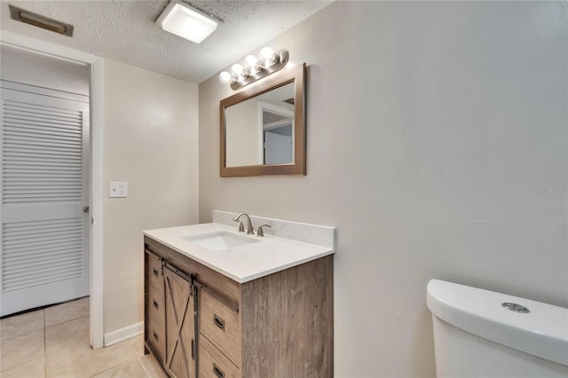 125 Picardy Villa Cir Unit 100, Brandon, FL 33510 - bathroom with vanity, toilet, a textured ceiling, and tile patterned floors