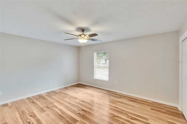 125 Picardy Villa Cir Unit 100, Brandon, FL 33510 - unfurnished room with ceiling fan, baseboards, light wood-type flooring, and a textured ceiling