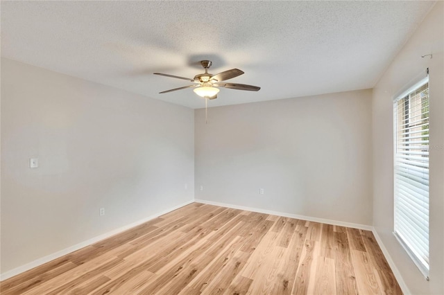 125 Picardy Villa Cir Unit 100, Brandon, FL 33510 - empty room featuring ceiling fan, light wood-style flooring, a textured ceiling, and baseboards