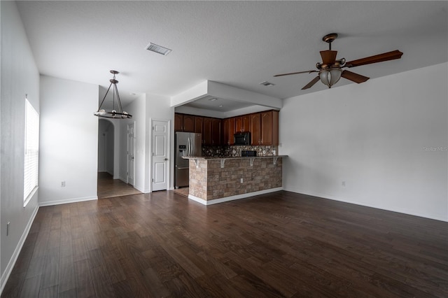 6940 47th Way N, Pinellas Park, FL 33781 - unfurnished living room with ceiling fan, a chandelier, dark wood finished floors, and baseboards