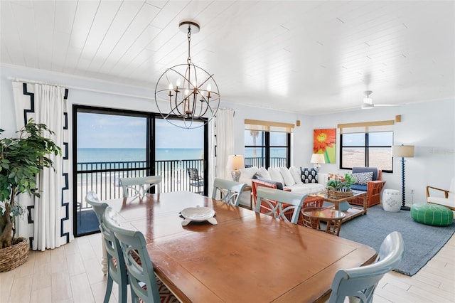 17334 Gulf Blvd Unit 203, North Redington Beach, FL 33708 - dining area with a chandelier, a water view, and light wood-style floors