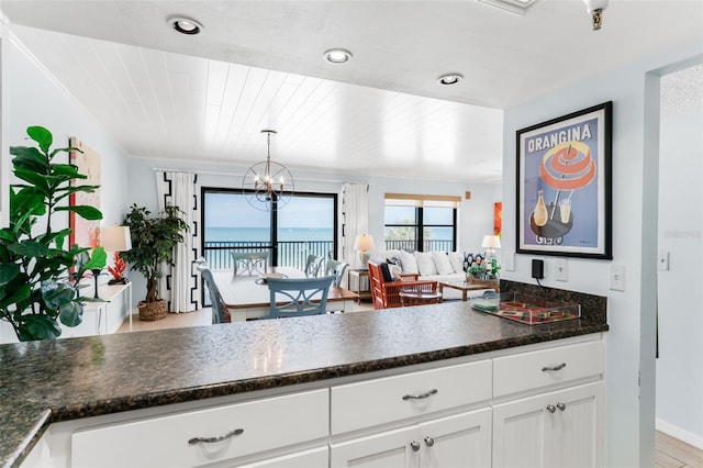 17334 Gulf Blvd Unit 203, North Redington Beach, FL 33708 - kitchen with white cabinetry, a chandelier, open floor plan, hanging light fixtures, and recessed lighting