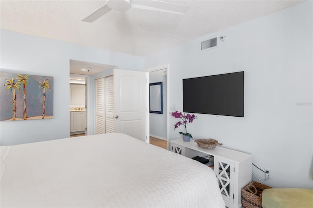 17334 Gulf Blvd Unit 203, North Redington Beach, FL 33708 - bedroom with a closet, connected bathroom, and a ceiling fan