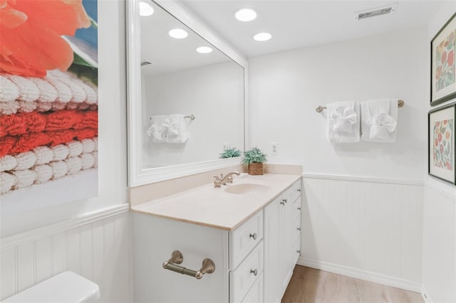 17334 Gulf Blvd Unit 203, North Redington Beach, FL 33708 - half bath with vanity, wainscoting, wood finished floors, and recessed lighting
