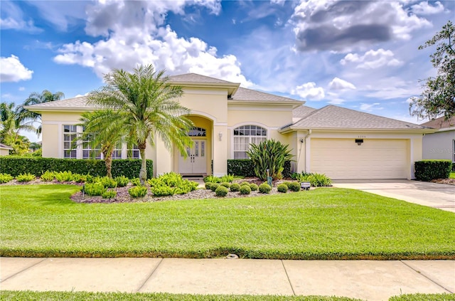 4304 Place Le Manes, Lutz, FL 33558 - mediterranean / spanish house with an attached garage, concrete driveway, a front yard, and stucco siding