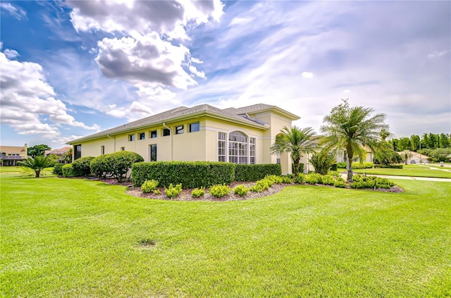 4304 Place Le Manes, Lutz, FL 33558 - view of property exterior featuring a lawn and stucco siding