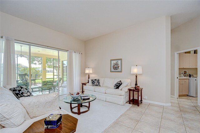 4304 Place Le Manes, Lutz, FL 33558 - living area featuring light tile patterned floors, baseboards, washer / clothes dryer, and ceiling fan