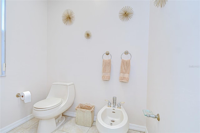 4304 Place Le Manes, Lutz, FL 33558 - bathroom with a bidet, toilet, baseboards, and tile patterned floors