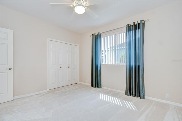 4304 Place Le Manes, Lutz, FL 33558 - unfurnished bedroom with light carpet, a closet, baseboards, and a ceiling fan