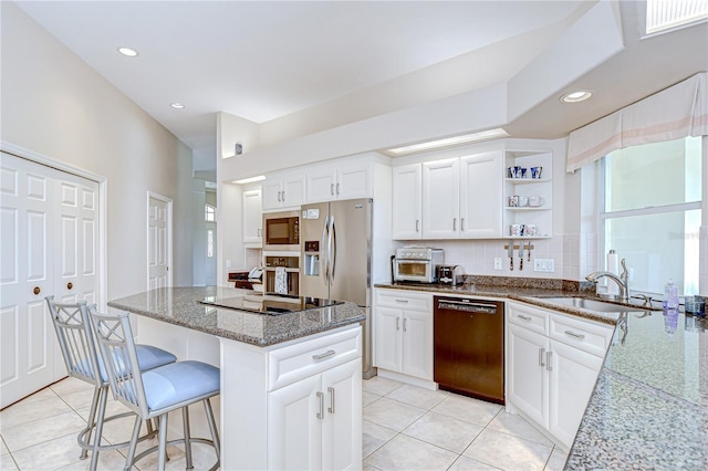 4304 Place Le Manes, Lutz, FL 33558 - kitchen featuring appliances with stainless steel finishes, light tile patterned floors, light stone counters, a sink, and open shelves