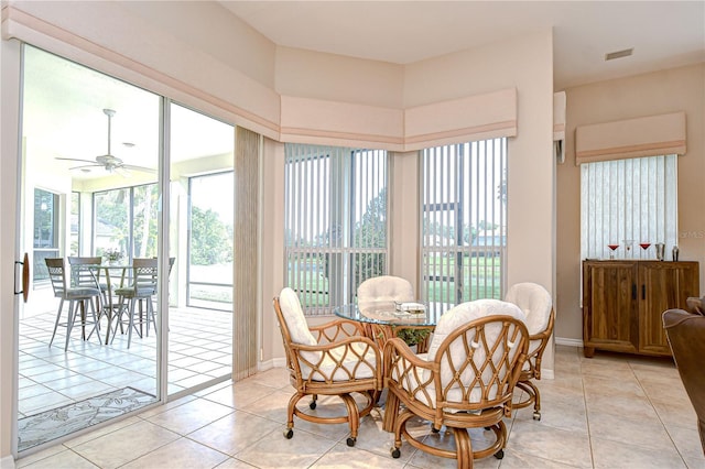 4304 Place Le Manes, Lutz, FL 33558 - dining area with a ceiling fan, light tile patterned flooring, and baseboards
