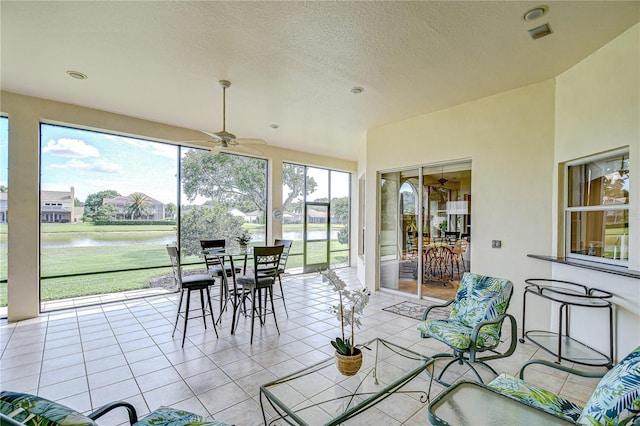 4304 Place Le Manes, Lutz, FL 33558 - sunroom / solarium featuring a water view, tile patterned flooring, a textured ceiling, and recessed lighting
