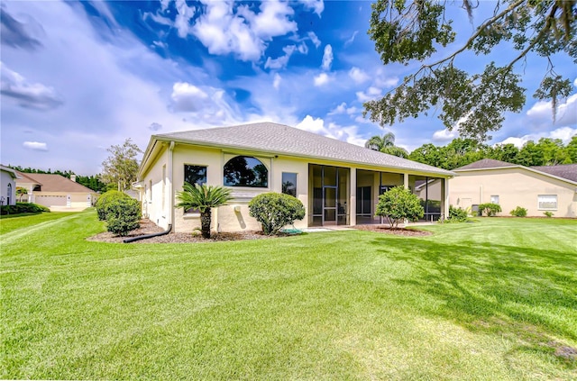 4304 Place Le Manes, Lutz, FL 33558 - back of property featuring a sunroom, a lawn, and stucco siding