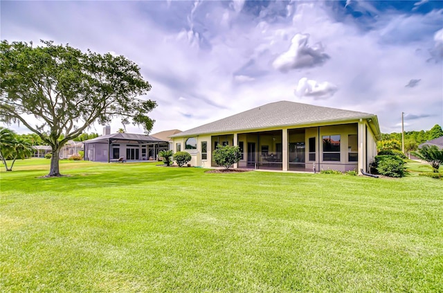 4304 Place Le Manes, Lutz, FL 33558 - back of property with a lawn and a sunroom