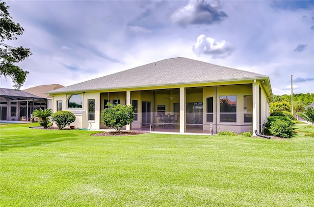 4304 Place Le Manes, Lutz, FL 33558 - rear view of house with a lawn and a sunroom