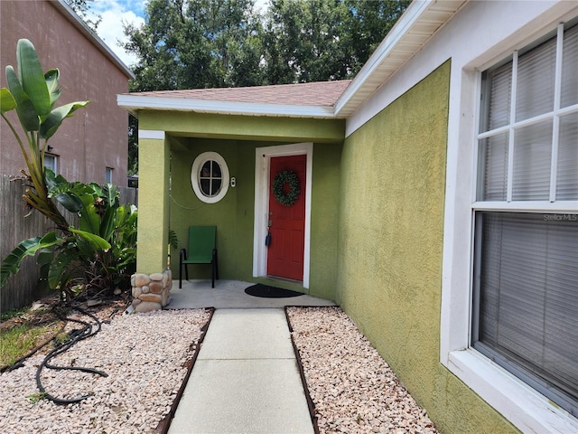 8313 Arabian Dunes Pl, Riverview, FL 33578 - view of exterior entry with stucco siding and a shingled roof