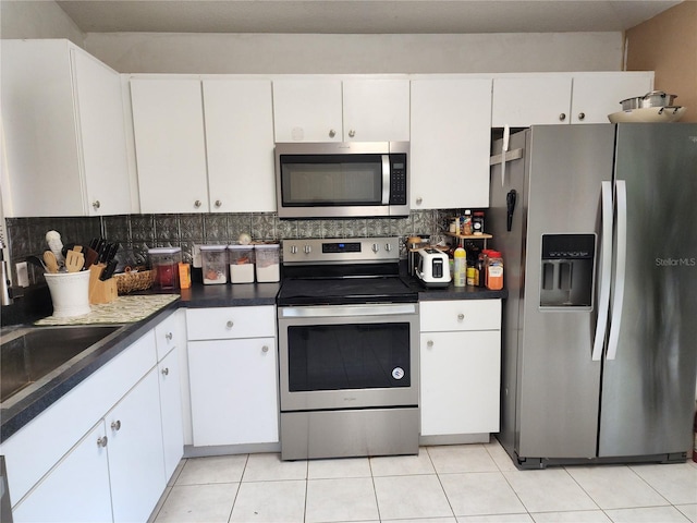 8313 Arabian Dunes Pl, Riverview, FL 33578 - kitchen featuring appliances with stainless steel finishes, tasteful backsplash, and white cabinets