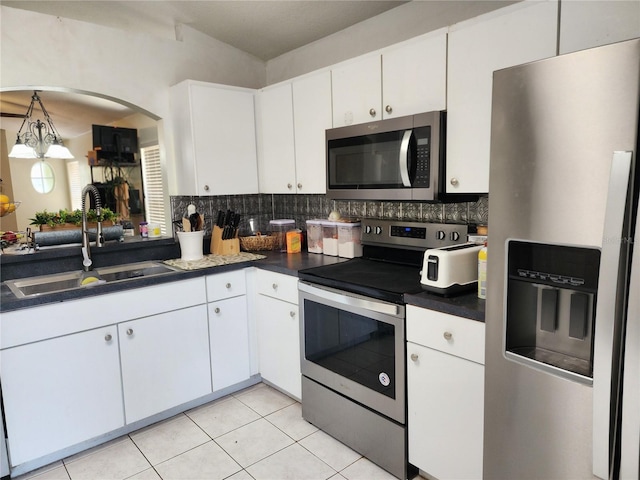8313 Arabian Dunes Pl, Riverview, FL 33578 - kitchen with stainless steel appliances, dark countertops, and white cabinetry