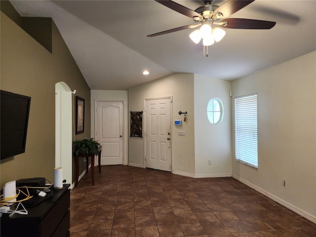 8313 Arabian Dunes Pl, Riverview, FL 33578 - foyer entrance featuring ceiling fan, lofted ceiling, dark stone finish floors, and arched walkways