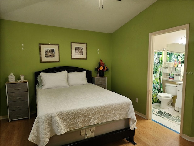 8313 Arabian Dunes Pl, Riverview, FL 33578 - bedroom featuring lofted ceiling, wood finished floors, and connected bathroom