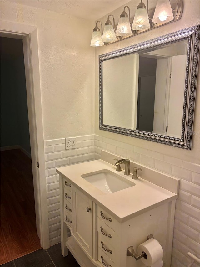 4020 55th St N Unit 1106, Kenneth City, FL 33709 - bathroom featuring tile walls, vanity, and a wainscoted wall