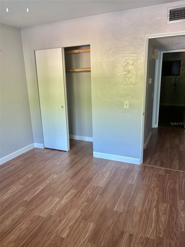 4020 55th St N Unit 1106, Kenneth City, FL 33709 - unfurnished bedroom featuring wood finished floors, baseboards, and a closet