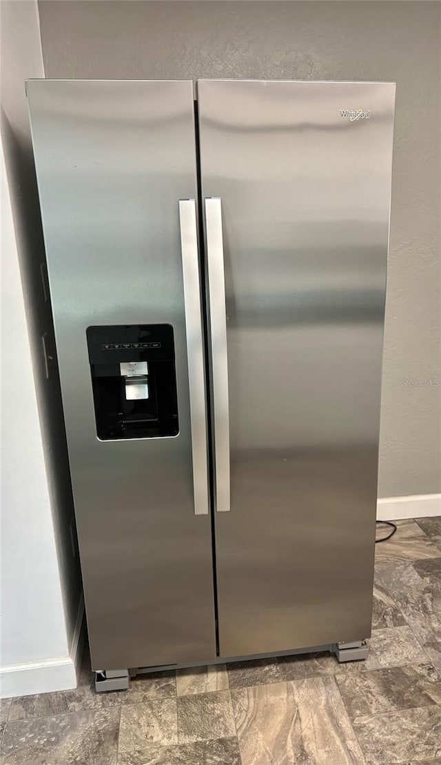 4020 55th St N Unit 1106, Kenneth City, FL 33709 - detailed view of stainless steel fridge with ice dispenser and baseboards