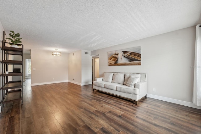 2461 Rhodesian Dr Unit 47, Clearwater, FL 33763 - living room featuring a textured ceiling, dark wood-type flooring, a chandelier, and baseboards