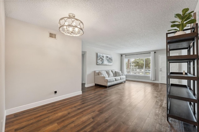 2461 Rhodesian Dr Unit 47, Clearwater, FL 33763 - living room with a textured ceiling, dark wood-type flooring, a chandelier, and baseboards