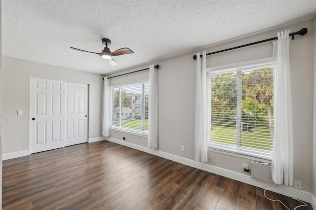 2461 Rhodesian Dr Unit 47, Clearwater, FL 33763 - unfurnished bedroom featuring dark wood-style floors, baseboards, a textured ceiling, ceiling fan, and a closet