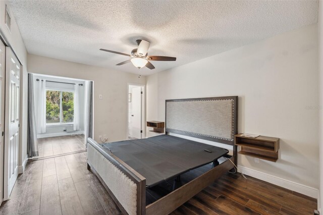 2461 Rhodesian Dr Unit 47, Clearwater, FL 33763 - bedroom featuring hardwood / wood-style floors, a textured ceiling, baseboards, and ceiling fan