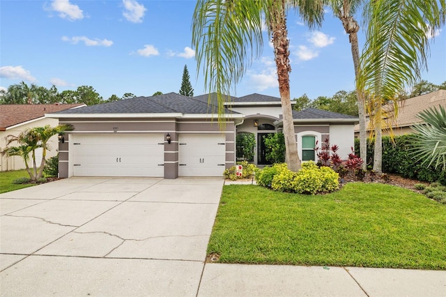 4505 Anaconda Dr, New Port Richey, FL 34655 - view of front of property featuring stucco siding, an attached garage, a front yard, and driveway